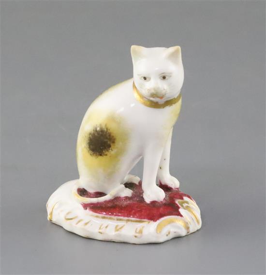 A rare Rockingham porcelain figure of a seated cat, c.1830, H. 5.5cm